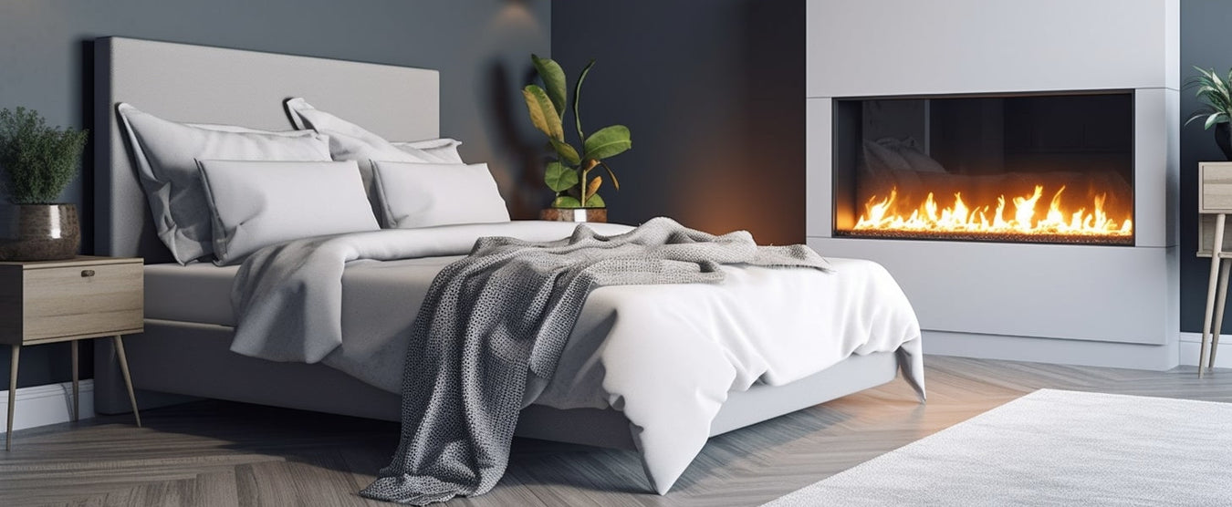 bedroom fireplace with a cozy bed nearby with white surround