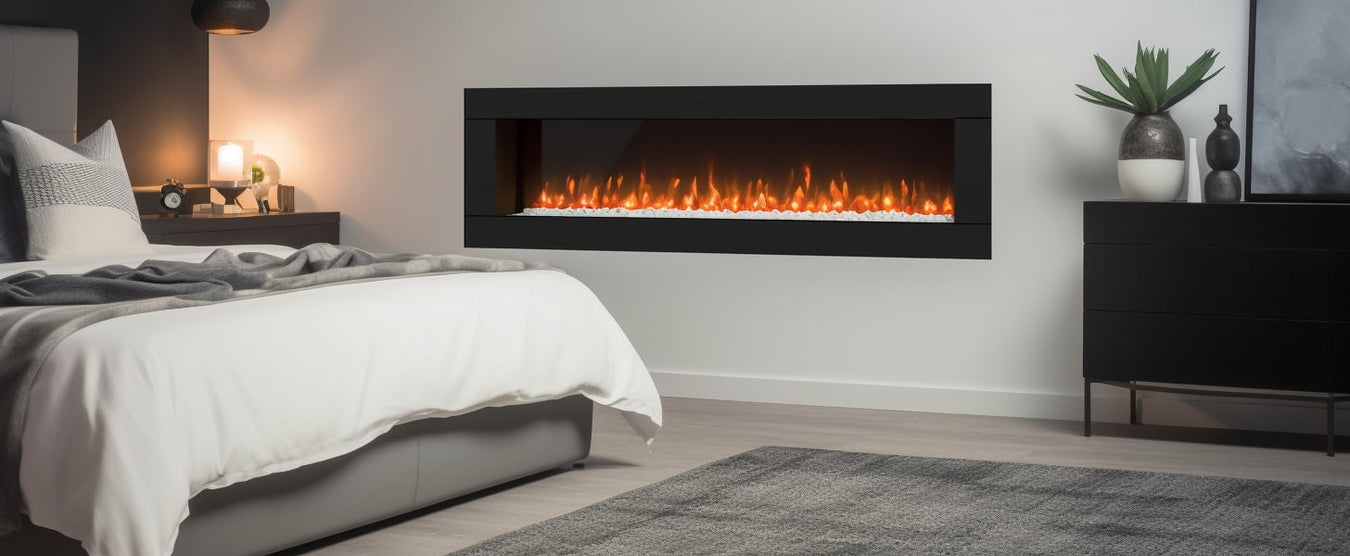 A electric fire with coals in the wall in a bedroom by a bed 