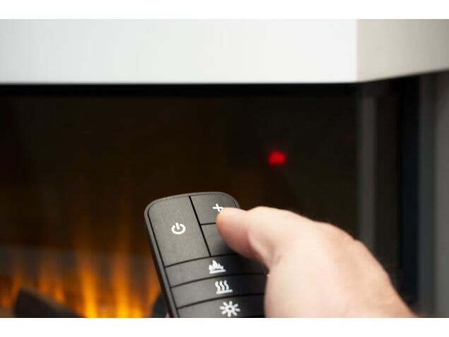 A person holding a remote control and pointing it at the adam sahara 42 inch