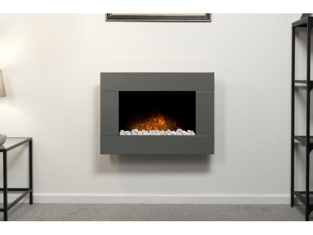 white wall and a grey fire hanging on it with pebbles 