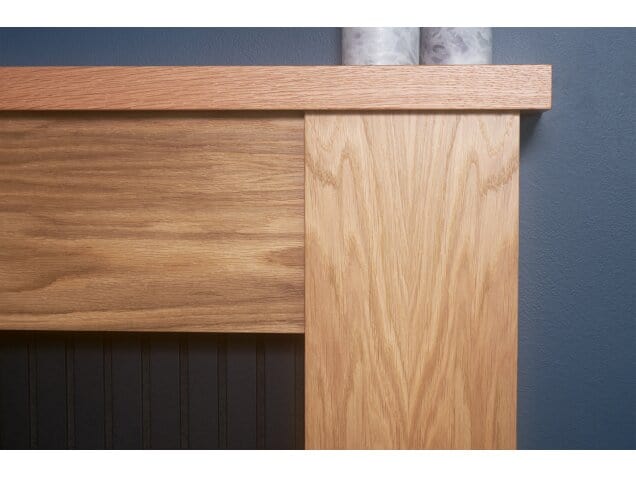 oak and black edge against wall of new england stove fireplace