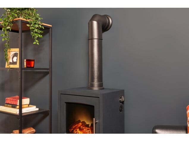 tall angled stove pipe in black connected to wall and the Adam Bergen XL electric stove