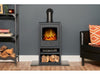 black angled stove pipe on a electric stove with a book shelf to the left